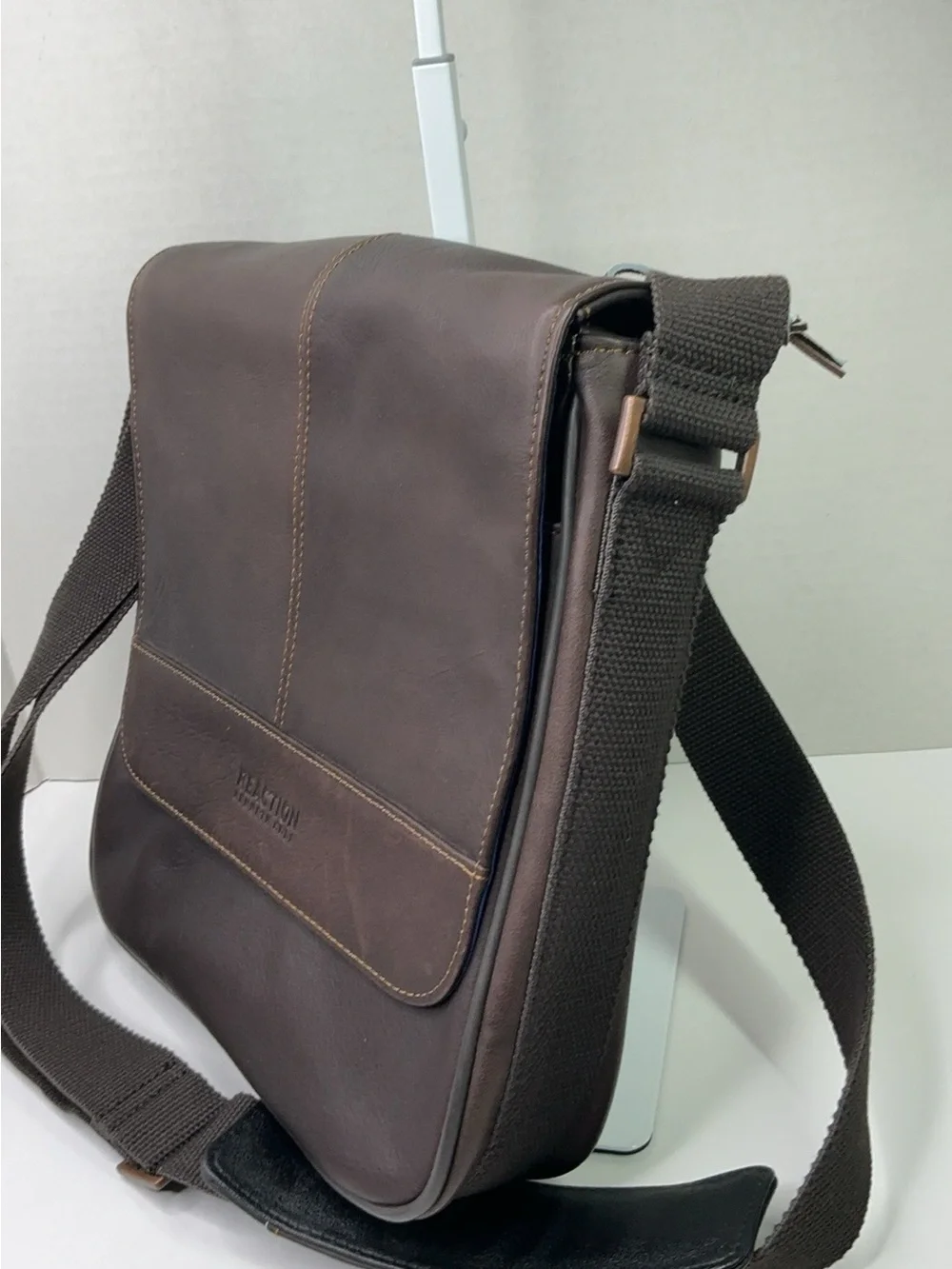 Kenneth Cole Reaction dark brown leather messenger-style tablet bag.